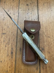 Buck Knife: 1989 Model Buck 110 Classic with Aged Stag Handle and Damascus Blade and Leather Pouch