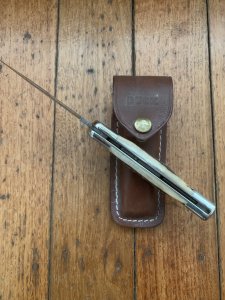 Buck Knife: 1989 Model Buck 110 Classic with Aged Stag Handle and Damascus Blade and Leather Pouch