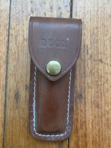 Buck Knife: 1989 Model Buck 110 Classic with Aged Stag Handle and Damascus Blade and Leather Pouch