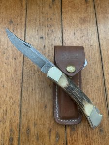 Buck Knife: 1989 Model Buck 110 Classic with Aged Stag Handle and Damascus Blade and Leather Pouch