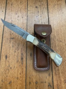 Buck Knife: 1989 Model Buck 110 Classic with Aged Stag Handle and Damascus Blade and Leather Pouch