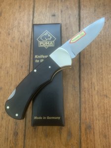 Puma Knife: Puma 2025 Date Stamp 4 Star Folding Lock Blade Knife with Black Buffalo Handle