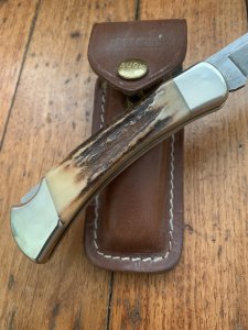 Buck Knife: 1989 Model Buck 110 Classic with Aged Stag Handle and Damascus Blade and Leather Pouch