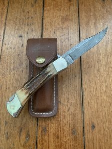 Buck Knife: 1989 Model Buck 110 Classic with Aged Stag Handle and Damascus Blade and Leather Pouch