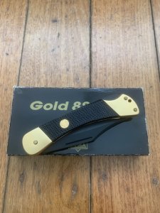 Puma Knife: Puma Rare 1988 Commando 24 Carat GOLD 88 Model Lock back Knife with Black ABS Handle & Original Box #44882