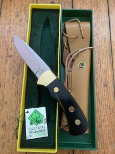Puma Knife: Puma Original 1992 4 Star Fixed Blade Knife with Black Ebony Handle in Original Green and Yellow Box #26291