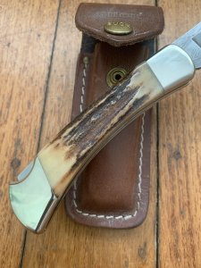 Buck Knife: 1989 Model Buck 110 Classic with Aged Stag Handle and Damascus Blade and Leather Pouch